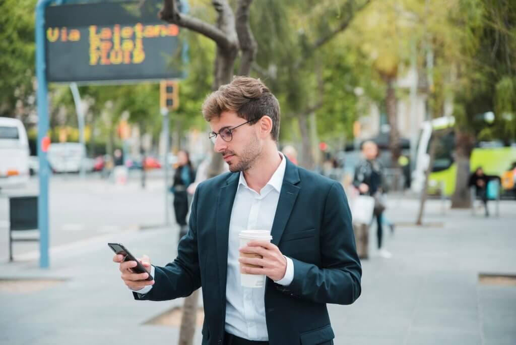 young businessman using erp solution on mobile
